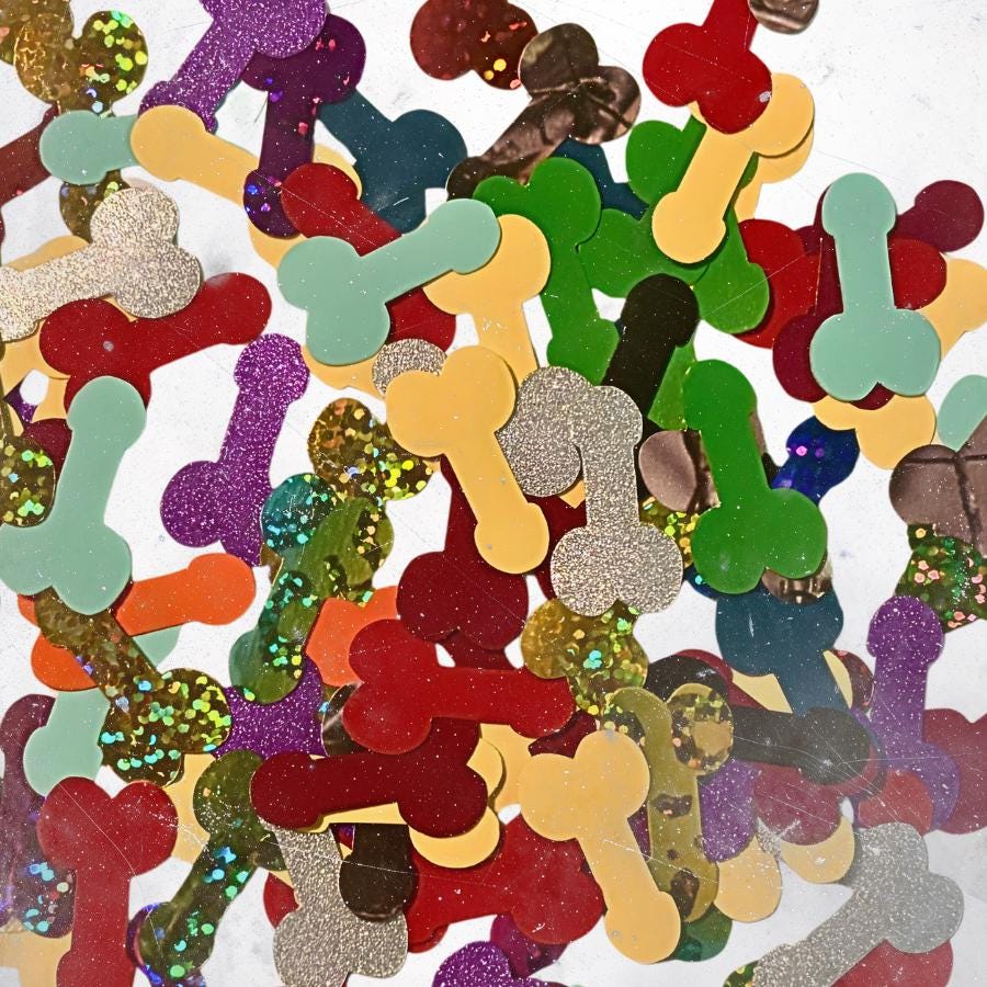 A collection of scattered confetti pieces shaped like bones in various colors and finishes, including solid red, green, yellow, and light blue, alongside glittery purple, gold, silver, and multi-colored textured surfaces.
